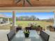 Relaxing covered patio with seating area and view of the backyard at 8459 Harvey Walden Dr, Plant City, FL 33565