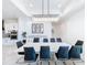 Spacious dining room features a large table, chandelier and modern chairs at 8459 Harvey Walden Dr, Plant City, FL 33565