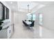 Elegant dining room features a large table, chandelier and modern chairs at 8459 Harvey Walden Dr, Plant City, FL 33565