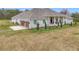 This home features a three-car garage and extensive landscaping at 8459 Harvey Walden Dr, Plant City, FL 33565