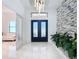 Bright and airy foyer with tile floors and statement lighting at 8459 Harvey Walden Dr, Plant City, FL 33565