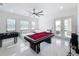 Game room with a pool table, foosball table, and access to a patio at 8459 Harvey Walden Dr, Plant City, FL 33565