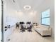 Spacious home office with white sofa, large desk, and whiteboard at 8459 Harvey Walden Dr, Plant City, FL 33565