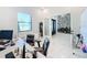 Home office with desk, chairs, and view into entryway at 8459 Harvey Walden Dr, Plant City, FL 33565