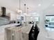 Modern kitchen with large island, stainless steel appliances, and white cabinets at 8459 Harvey Walden Dr, Plant City, FL 33565