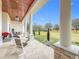 Spacious covered porch overlooking the backyard and trees at 8459 Harvey Walden Dr, Plant City, FL 33565