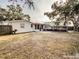 Large backyard with screened enclosure and patio at 9825 Lakeside Ln, Port Richey, FL 34668