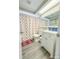 Clean bathroom with white vanity and patterned shower curtain at 9825 Lakeside Ln, Port Richey, FL 34668
