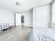 Spacious bedroom with large windows and access to another room at 9825 Lakeside Ln, Port Richey, FL 34668