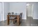 Dining area with a dark wood table and four chairs at 9825 Lakeside Ln, Port Richey, FL 34668