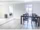 Dining room with table and chairs, hardwood floors, and view into another room at 9825 Lakeside Ln, Port Richey, FL 34668