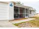 Inviting front entrance with a screened porch and walkway at 9825 Lakeside Ln, Port Richey, FL 34668