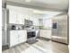 Modern kitchen with white cabinets, stainless steel appliances, and granite countertops at 9825 Lakeside Ln, Port Richey, FL 34668