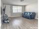 Living room with a black leather couch and large TV at 9825 Lakeside Ln, Port Richey, FL 34668