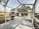 Spacious screened patio with wooden deck, perfect for outdoor relaxation at 9825 Lakeside Ln, Port Richey, FL 34668