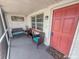 Relaxing screened porch with wicker chairs and a welcome mat at 9825 Lakeside Ln, Port Richey, FL 34668