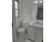 Clean bathroom with white vanity, toilet, and updated fixtures at 10202 Oak Hill Dr, Port Richey, FL 34668