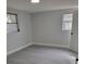 Spacious bedroom with gray walls, wood-look flooring, and multiple windows at 10202 Oak Hill Dr, Port Richey, FL 34668