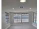 Bright and airy living room with recessed lighting and large windows overlooking the pool at 10202 Oak Hill Dr, Port Richey, FL 34668