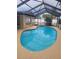 Inviting kidney-shaped pool with covered patio at 10202 Oak Hill Dr, Port Richey, FL 34668