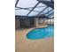 Inviting kidney-shaped pool with a screened enclosure at 10202 Oak Hill Dr, Port Richey, FL 34668