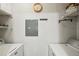 Bright laundry room with washer, dryer, and shelving at 10263 Gandy N Blvd # 2206, St Petersburg, FL 33702