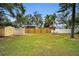 Grass and fenced backyard with shed and privacy fence at 1034 Sunnydale Dr, Clearwater, FL 33755