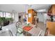 Kitchen dining area with a round glass table and wicker chairs at 1034 Sunnydale Dr, Clearwater, FL 33755