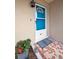 Close-up view of teal front door and stone-tiled porch at 1034 Sunnydale Dr, Clearwater, FL 33755