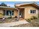 Inviting front entrance with teal door and stone accents at 1034 Sunnydale Dr, Clearwater, FL 33755