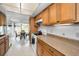 Kitchen features wood cabinets and a view into the sunroom at 1034 Sunnydale Dr, Clearwater, FL 33755