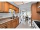 Well-lit kitchen with wood cabinets and stainless steel appliances at 1034 Sunnydale Dr, Clearwater, FL 33755