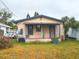 Back of house, small deck, and unkempt yard at 1106 Carlton St, Clearwater, FL 33755