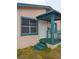 Teal-trimmed porch and entrance to a tan house at 1106 Carlton St, Clearwater, FL 33755