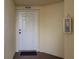 Condo building entry with white door and mat at 1200 Country Club Dr # 6206, Largo, FL 33771