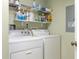 Bright laundry room with washer, dryer, and shelving at 1200 Country Club Dr # 6206, Largo, FL 33771