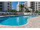 Community pool with clear blue water and lounge seating at 1200 Country Club Dr # 6206, Largo, FL 33771