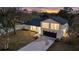 Nighttime aerial view highlights the home's curb appeal and unique architecture at 12413 Gunstock Ln, Hudson, FL 34667