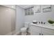 Modern bathroom with white cabinets, a shower and a toilet at 12413 Gunstock Ln, Hudson, FL 34667