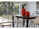 Modern dining room with dark wood table and white chairs at 12413 Gunstock Ln, Hudson, FL 34667