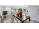 Modern dining room with dark wood table and white chairs at 12413 Gunstock Ln, Hudson, FL 34667