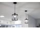 Modern kitchen lighting with two black pendant lights at 12413 Gunstock Ln, Hudson, FL 34667