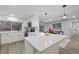 Modern kitchen with white cabinets, quartz counters, and island at 12413 Gunstock Ln, Hudson, FL 34667