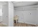 Bright laundry room with utility sink and shelving at 12413 Gunstock Ln, Hudson, FL 34667