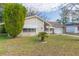 Well-maintained ranch house with a lush green lawn at 12512 River Mill Dr, Hudson, FL 34667