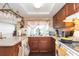 Galley kitchen with wood cabinets and a corner sink at 12512 River Mill Dr, Hudson, FL 34667