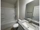 Bathroom with single vanity, granite countertop, and tub shower combo at 13251 Ogden Glade Rd, Dade City, FL 33525