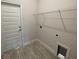 Laundry room with built-in shelving and vinyl flooring at 13251 Ogden Glade Rd, Dade City, FL 33525