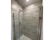 Modern shower with glass enclosure and gray tile at 13251 Ogden Glade Rd, Dade City, FL 33525