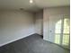 Bedroom with double doors and gray carpet at 13287 Ogden Glade Rd, Dade City, FL 33525